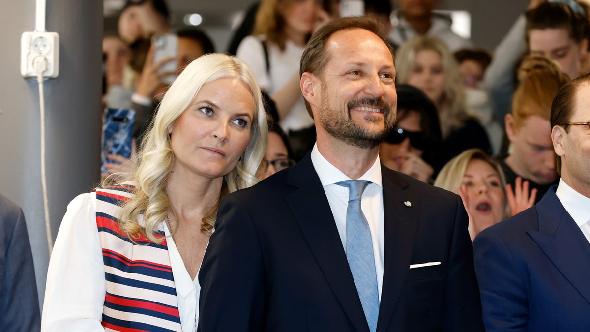 Crown Princess Mette-Marit of Norway, Crown Prince Haakon of Norway, and Prince Daniel of Sweden watching a performance.