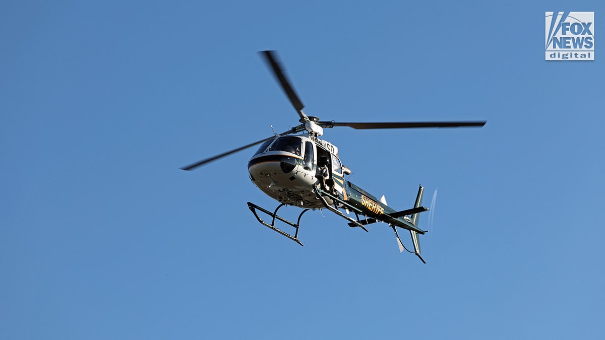 Nancy Guthrie's disappearance leads to a Pima County Sheriff helicopter flying over a desert landscape during a search operation for her