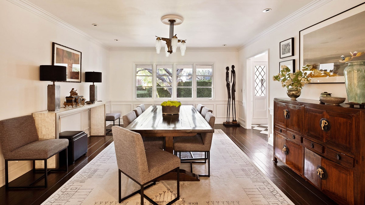 The formal dining area features a table large enough for eight diners.