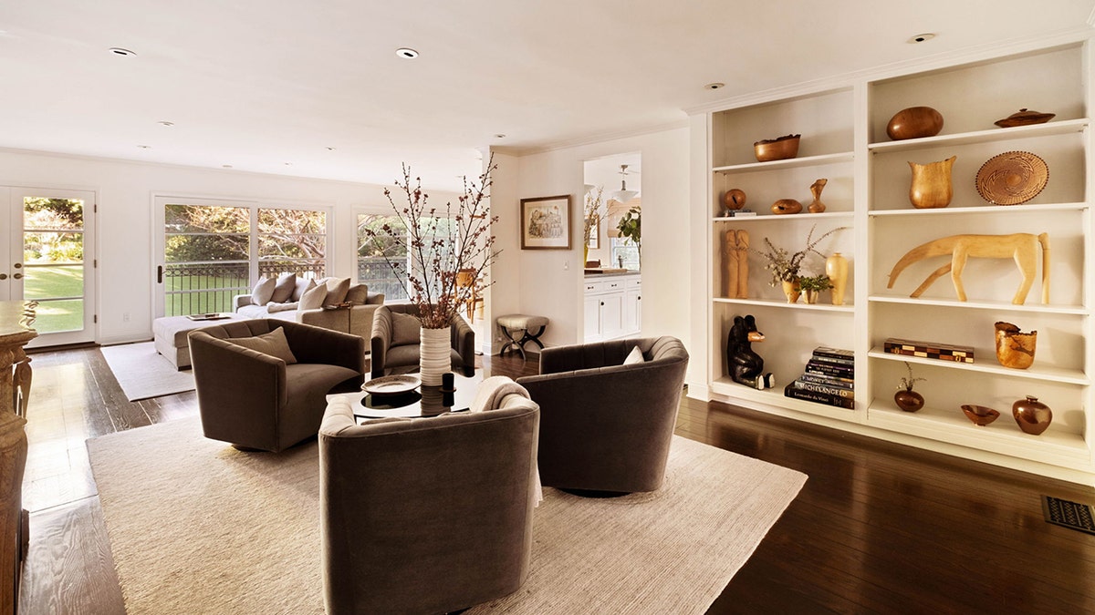 The family room features built-in shelving and a seating area.