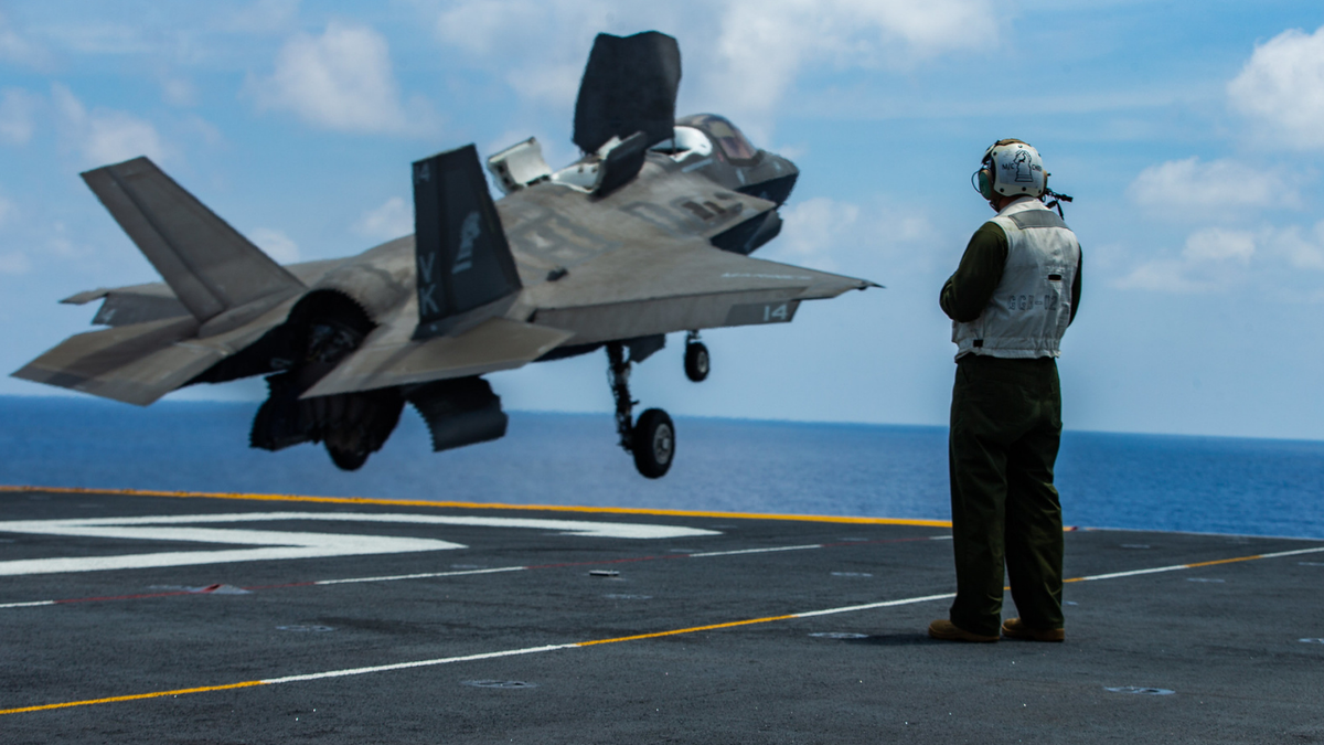 An F-35B jet is seen taking off from the flight deck of the USS America.