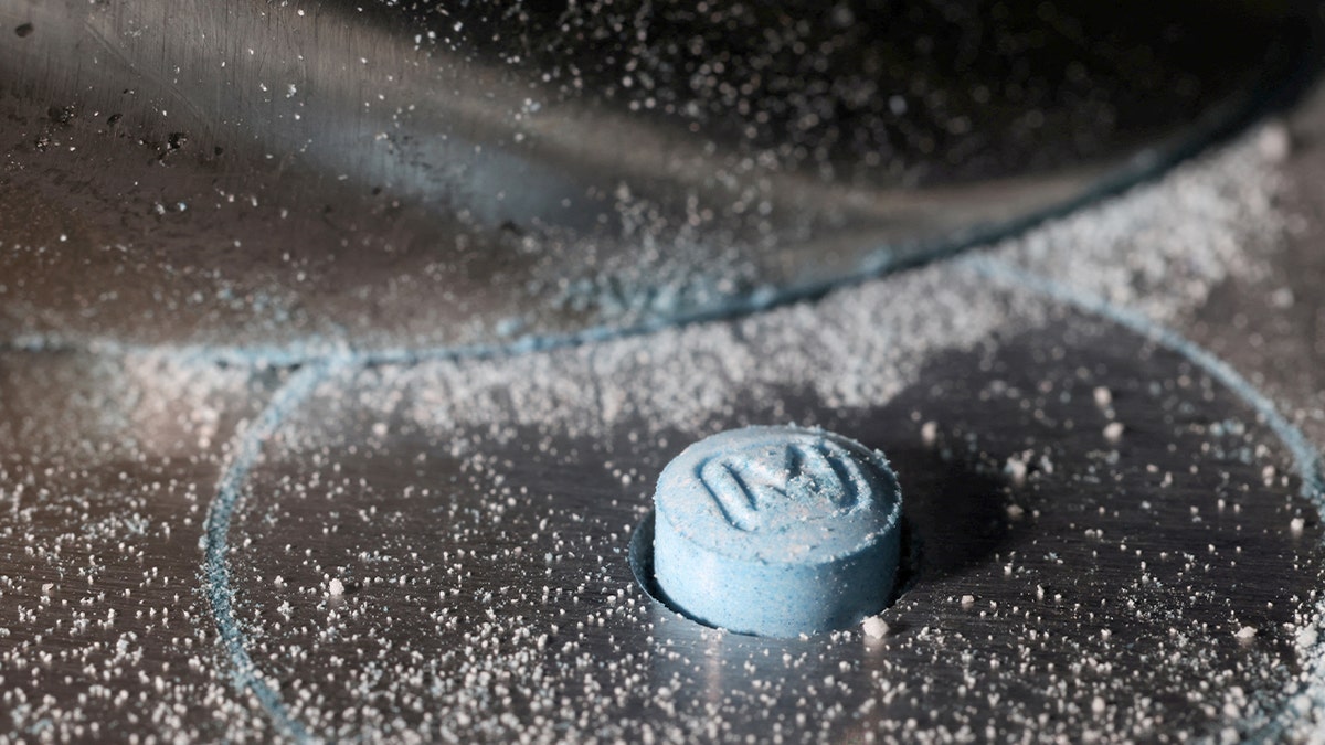 A close-up of a pill press machine shaping a tablet in New York City.