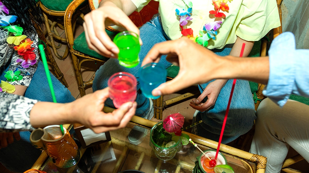 Partygoers toasting with Jell-O shots