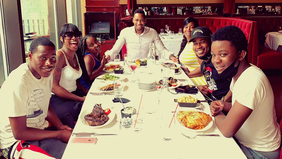 Gianno Caldwell astatine  an aboriginal  meal  celebrating his small  member  Christian's precocious   schoolhouse  graduation.