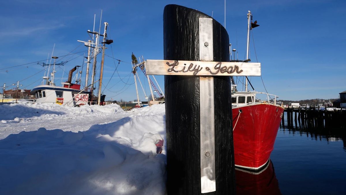 A crucifix, made by a person of the skipper of the sportfishing vessel "Lily Jean", is displayed connected the pier of the homeport of the sportfishing vessel that went missing with 7 onboard, Monday, Feb. 2, 2026, successful Gloucester, Mass. (AP Photo/Charles Krupa)