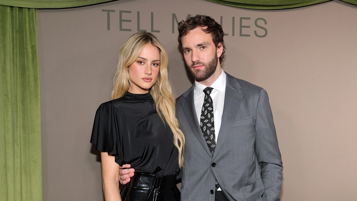 Grace Van Patten and Jackson White standing together and smiling at an indoor event.