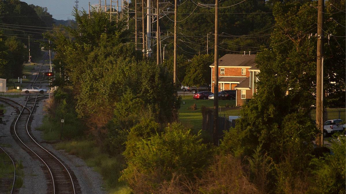 suburb of north carolina with trees and a rail track nearby