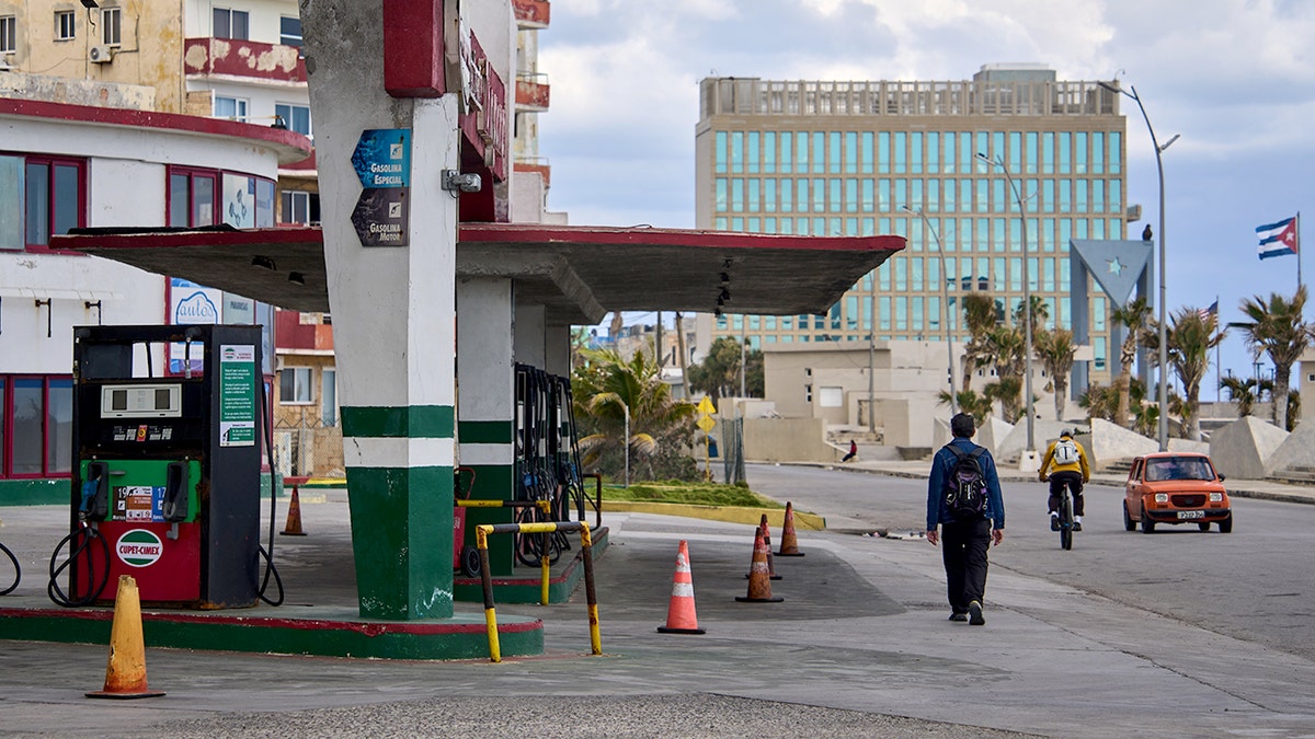 Man walks past gas station in Havana, Cuba
