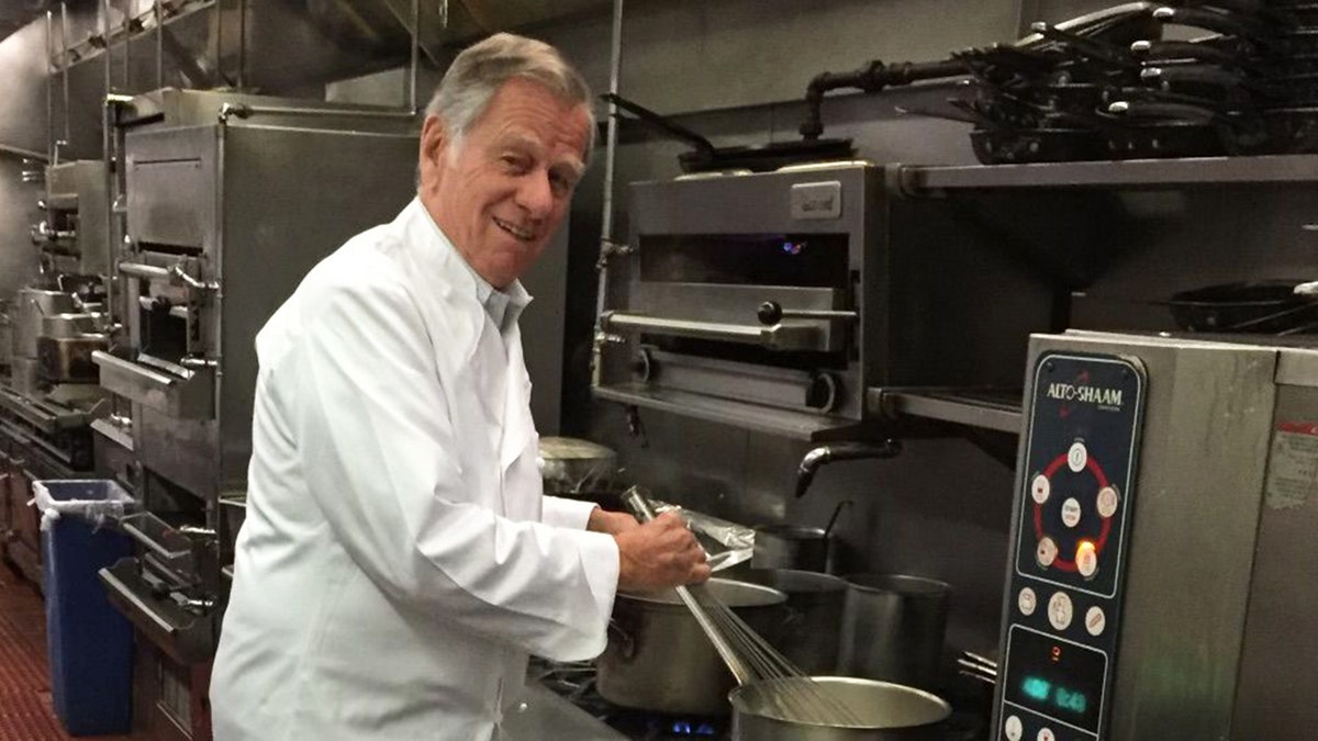 Helmut Huber in the kitchen cooking.