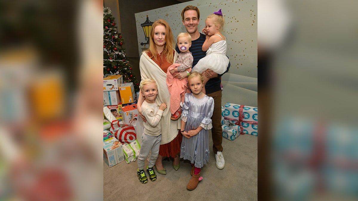 James Van Der Beek smiles next to his family