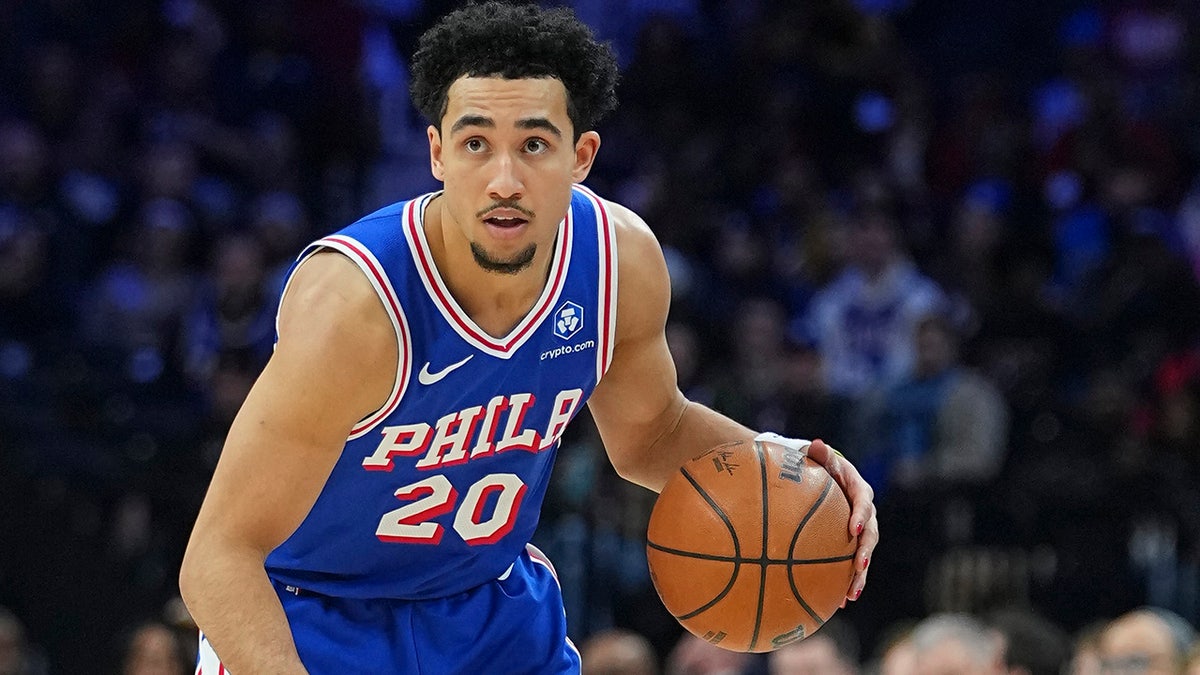 Jared McCain dribbles