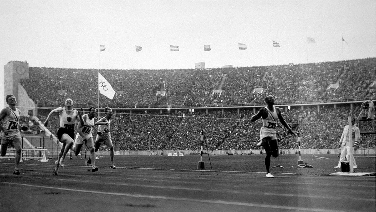 Jesse Owens winning the 100 meters successful 1936