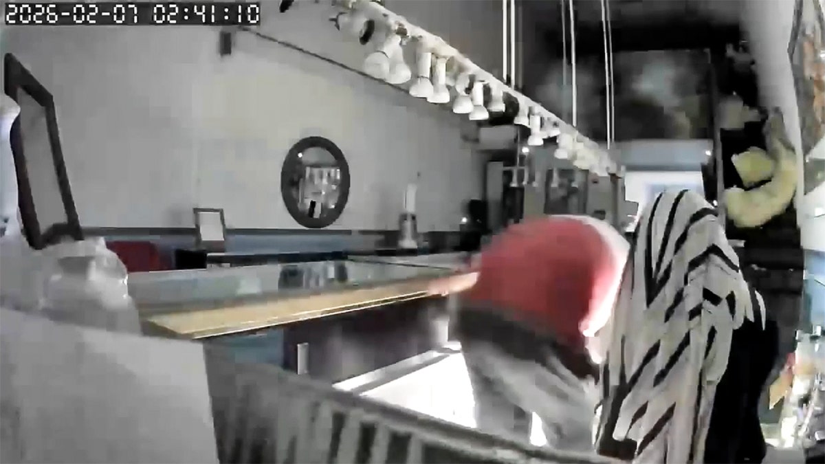 Burglar breaking into a jewelry store.