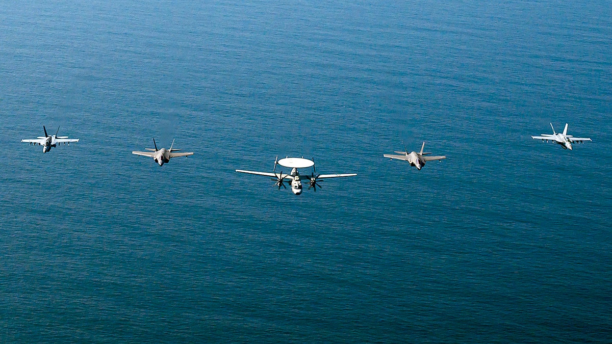 Fighter jets from Carrier Air Wing Nine conduct flight operations above the Arabian Sea