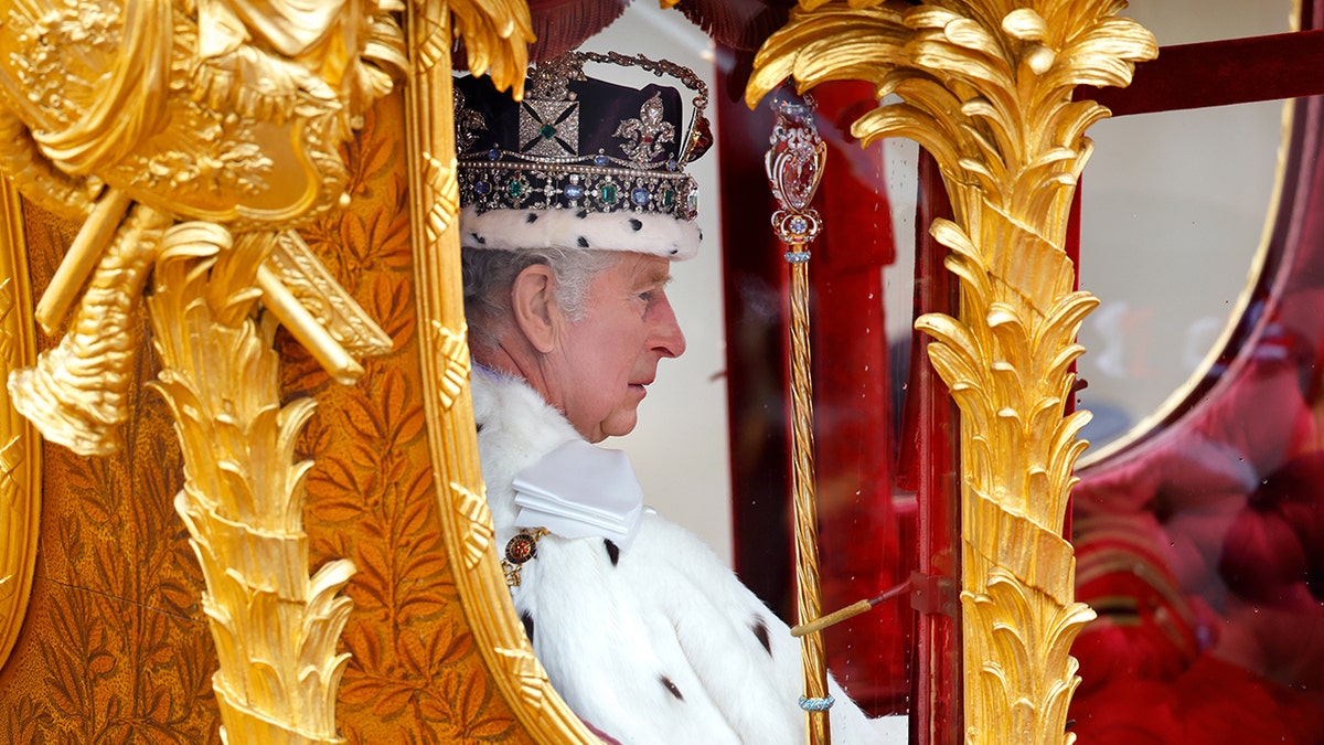 King Charles in a gold royal carriage.