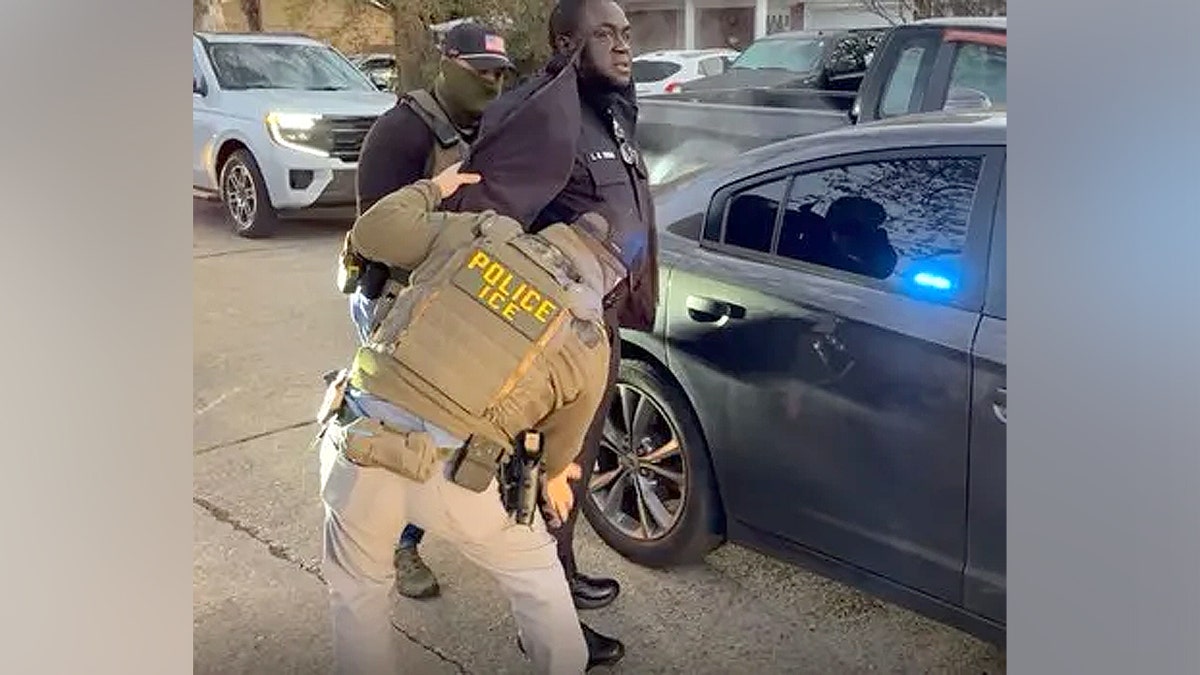 Larry Temah being detained.