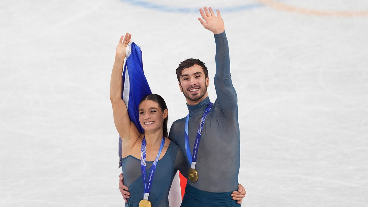 Laurence Fournier Beaudry and Guillaume Cizeron acknowledge a crowd of fans