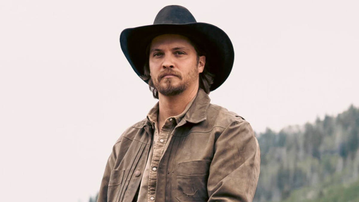 Luke Grimes as Kayce Dutton and Logan Marshall-Green as Pete Calvin standing together in a scene from Marshals
