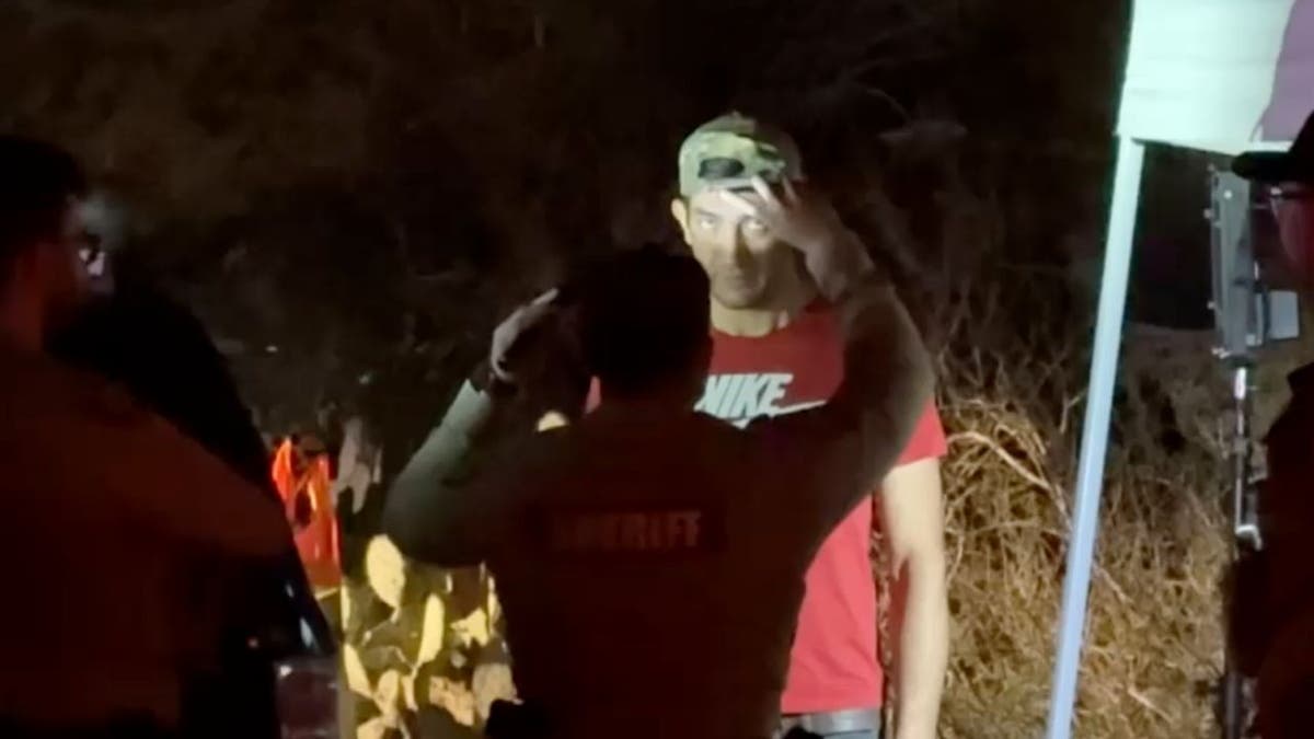 Deputy shining flashlight at man during sobriety test near Nancy Guthrie home