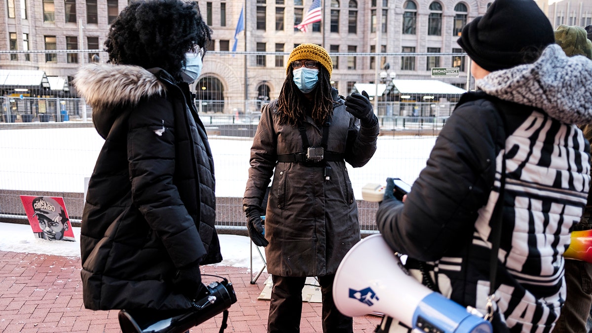Marcia Howard wearing disguise speaking with BLM activists successful snow