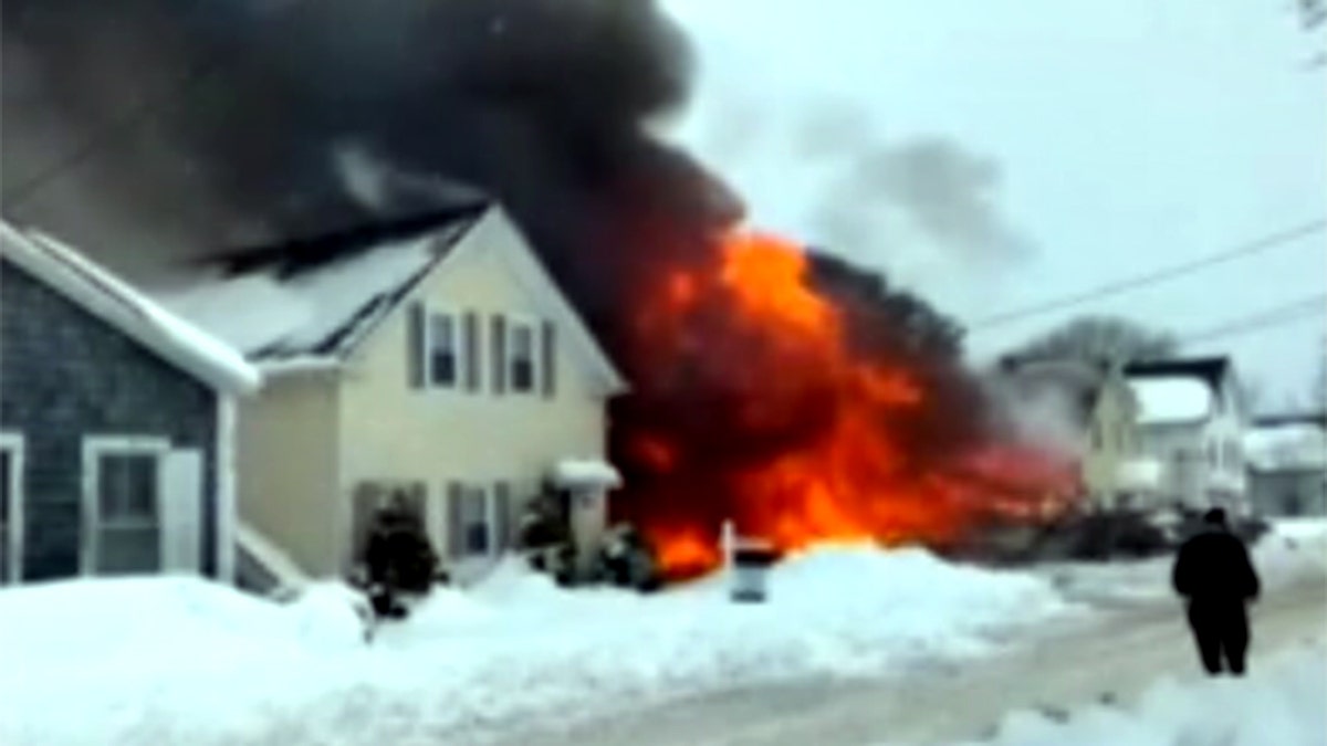 orange flames spewing from home