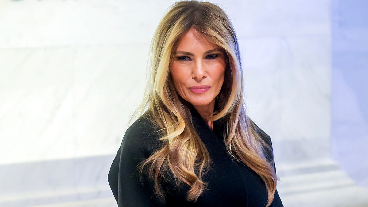 Melania Trump stands on New York Stock Exchange floor.