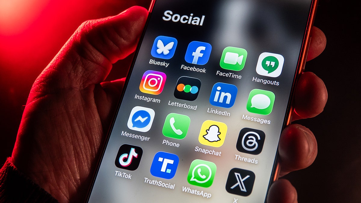 Person looking at apps on their phone.