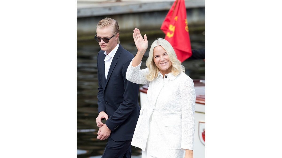 Crown Princess Mette-Marit of Norway and Marius Borg Hoiby standing together during a visit.