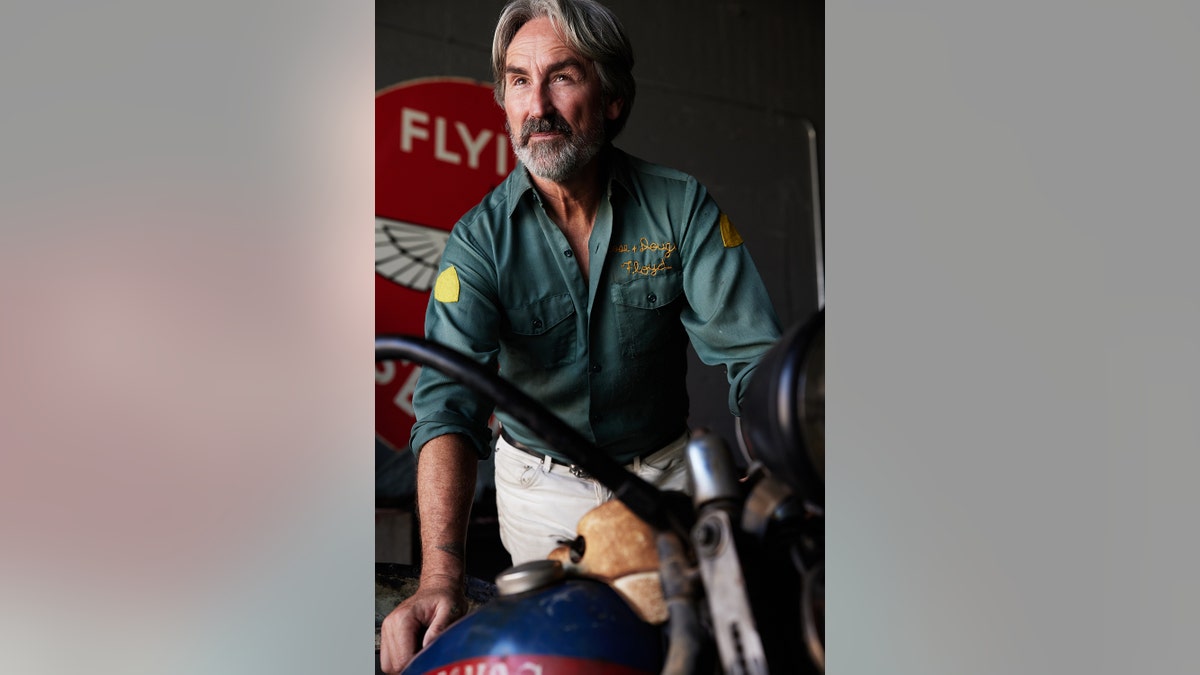 A close-up of Mike Wolfe on a bike looking away during "History's Greatest Picks."