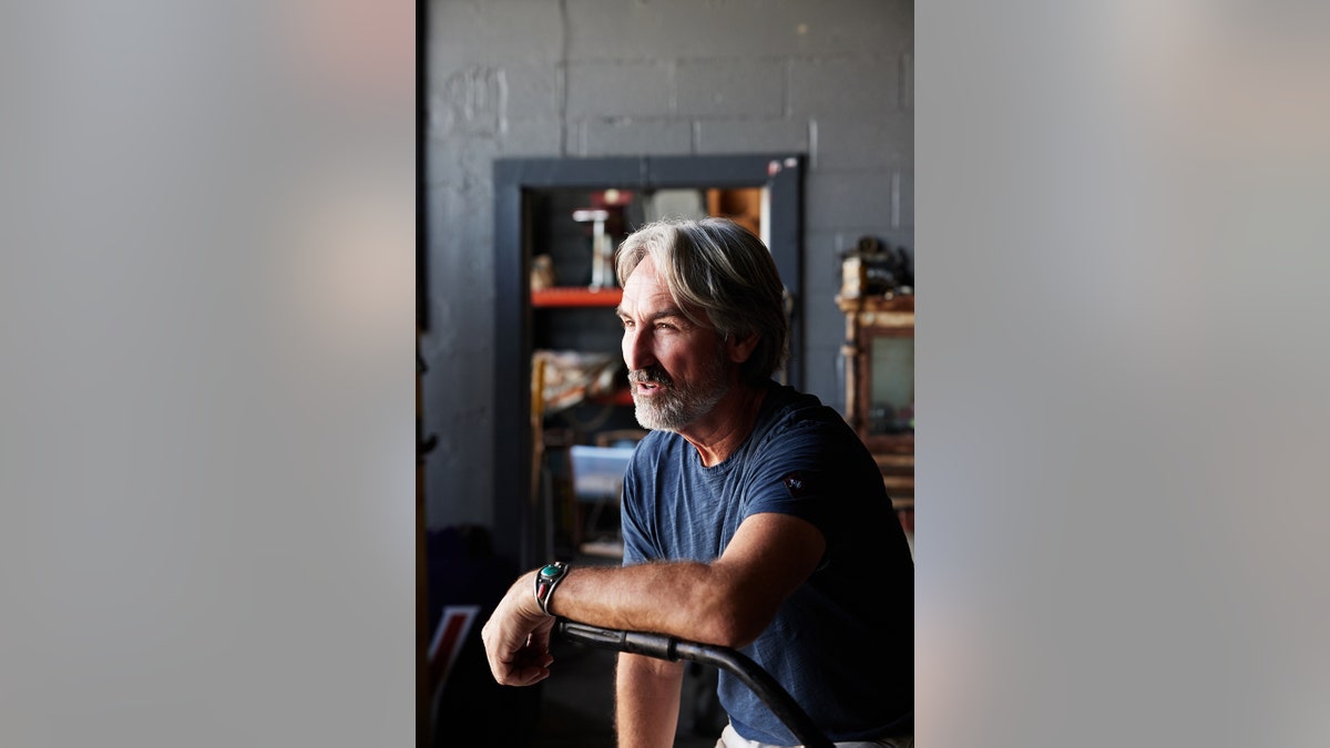 Mike Wolfe looking to the side as the host of "History's Greatest Picks."