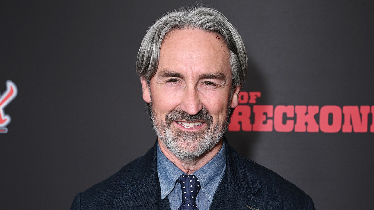 A close-up of Mike Wolfe smiling at a film premiere.