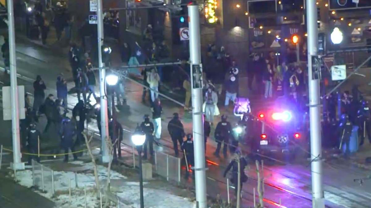 Police confront protesters during an anti-ICE demonstration outside a Minneapolis hotel near the University of Minnesota.