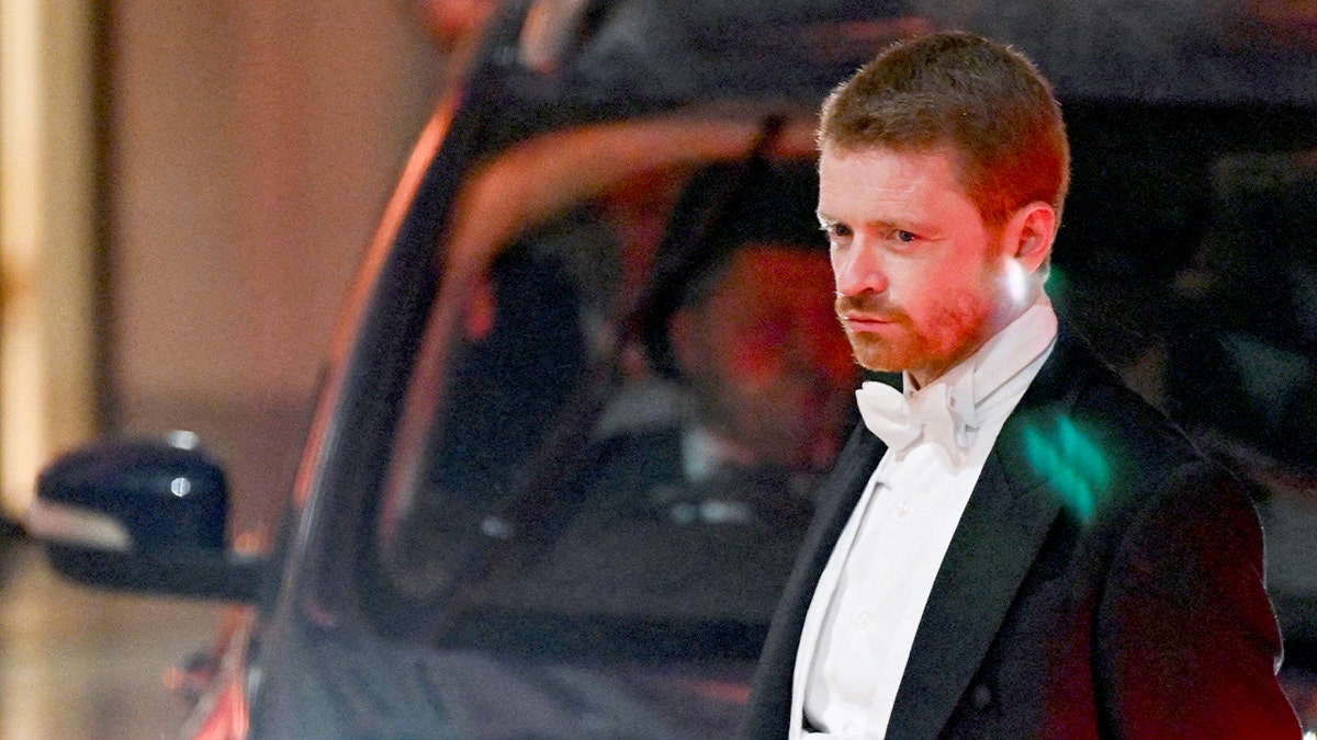 A senior British government aide arrives at a formal civic event in London.