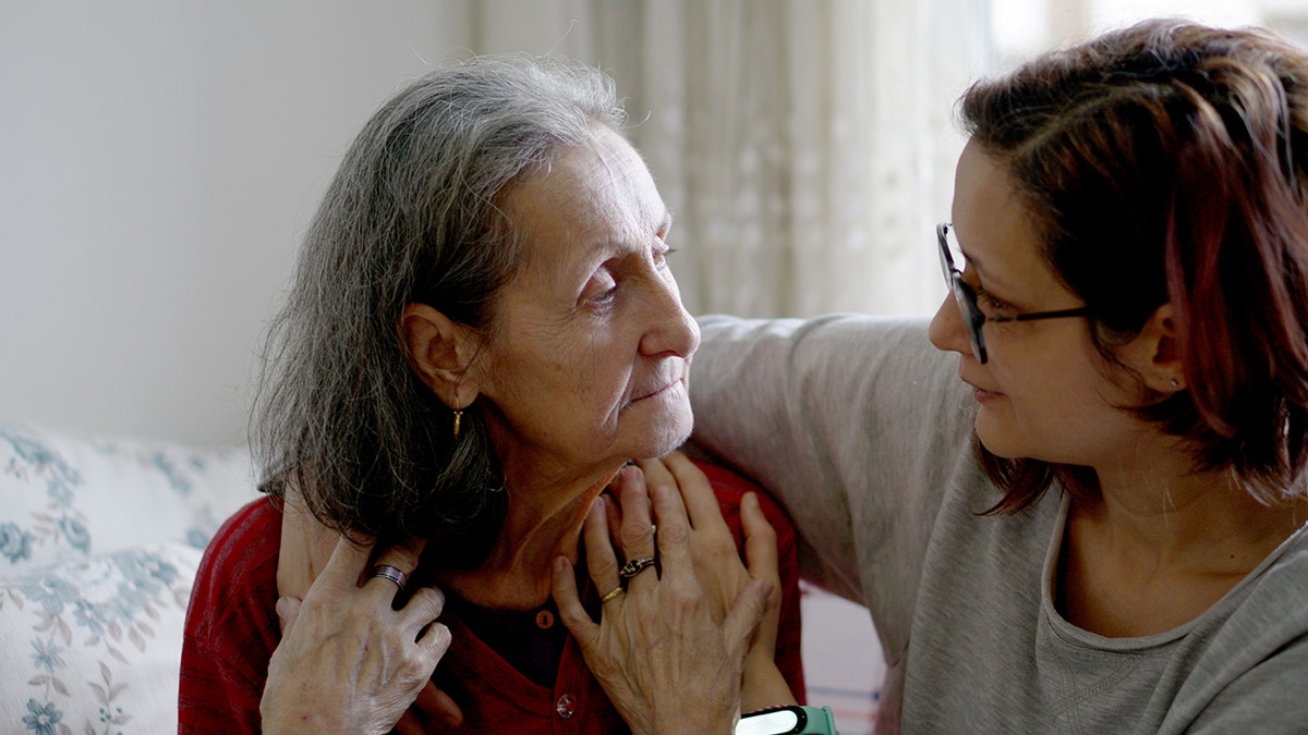 Woman hugging her elderly mother