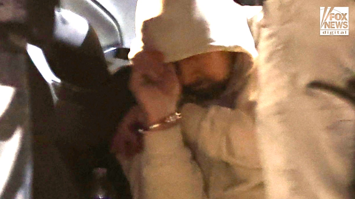 A man being detained by law enforcement following a traffic stop in Tucson, Arizona