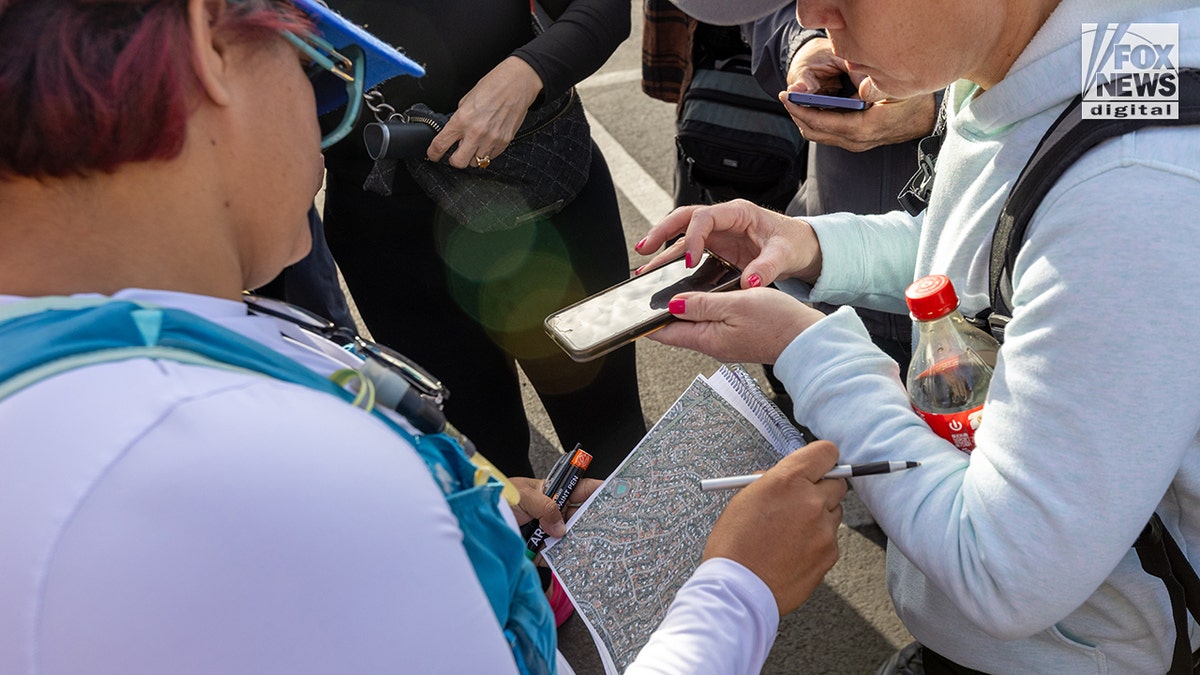 Nancy Guthrie case search volunteers walking through a desert landscape in Tucson, Arizona.