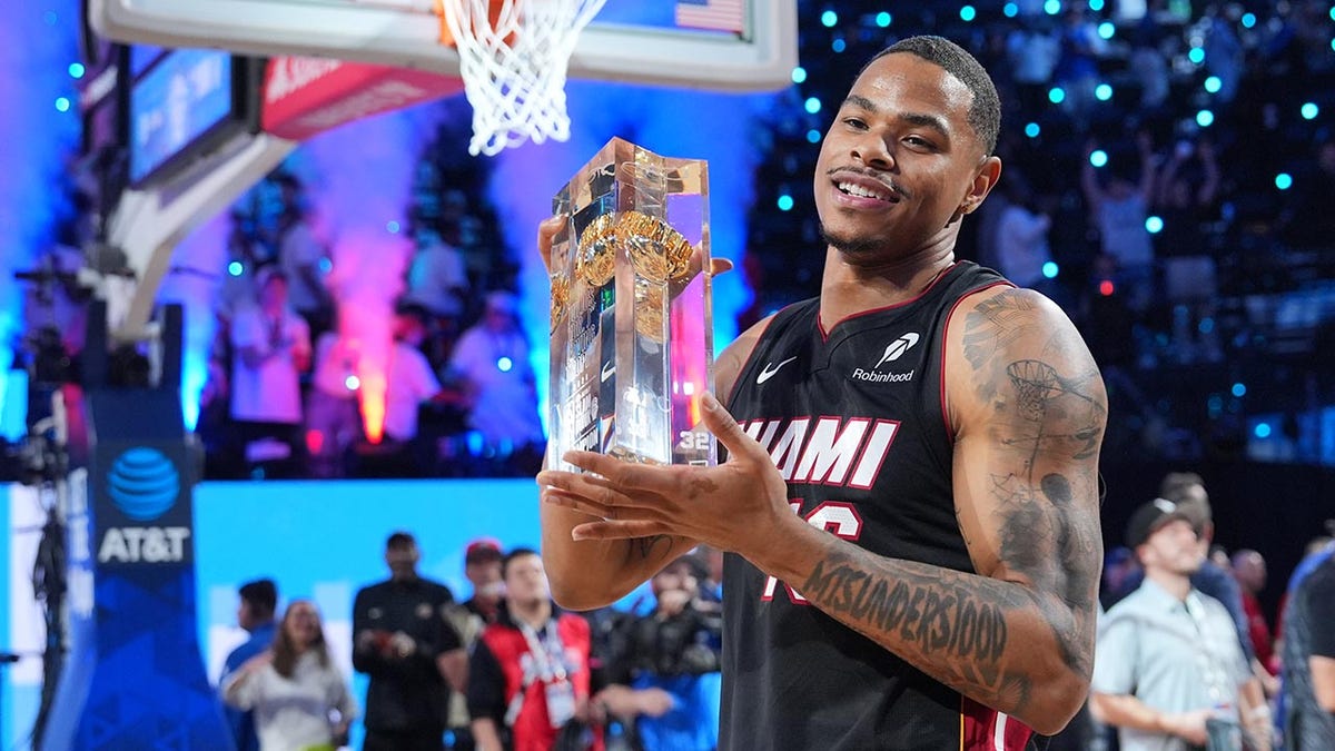 Magic's Jase Richardson falls on dunk attempt 3 Keshad Johnson holds the trophy