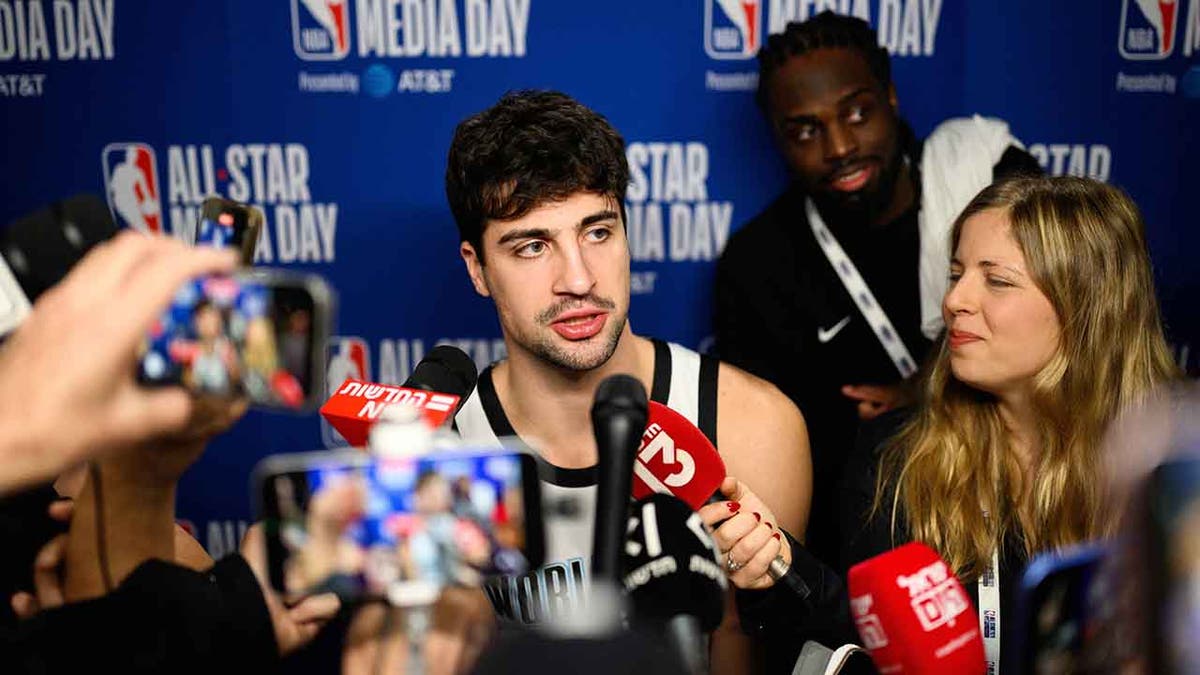 Deni Avdija talks to reporters