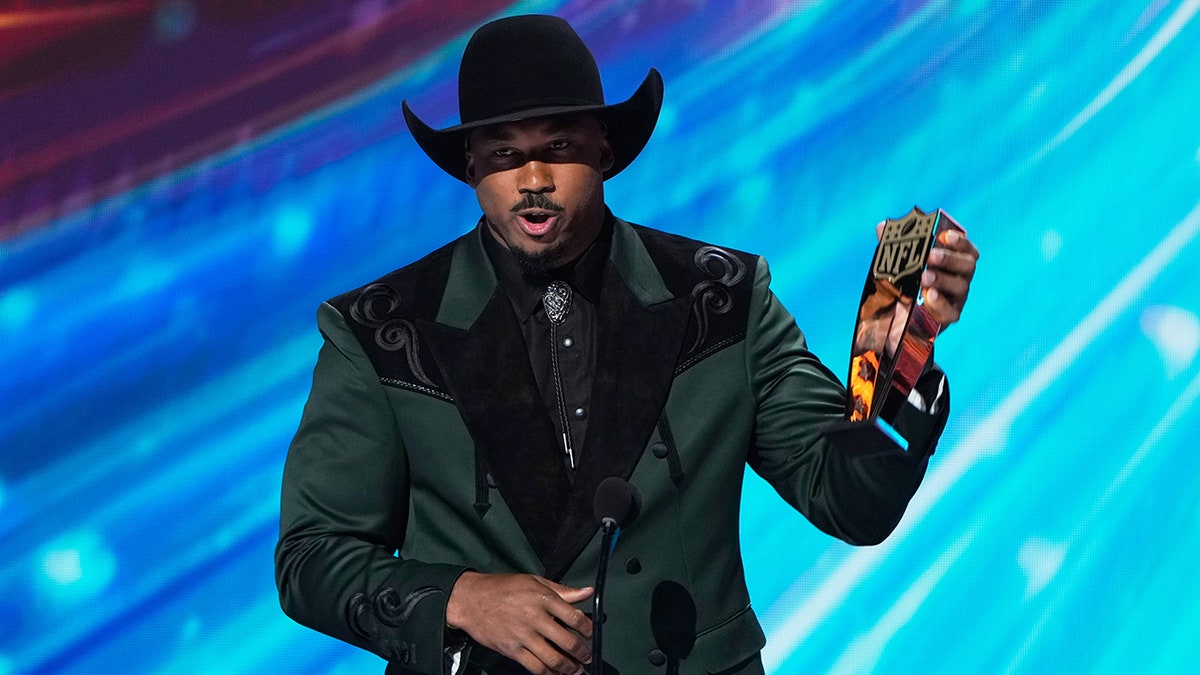 Myles Garrett accepts a Defensive Player of the Year award