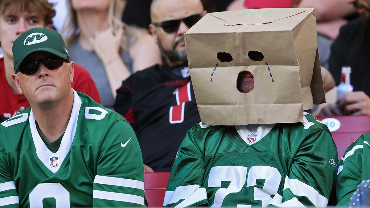 New York Jets fan wearing a paper bag over his head at State Farm Stadium.