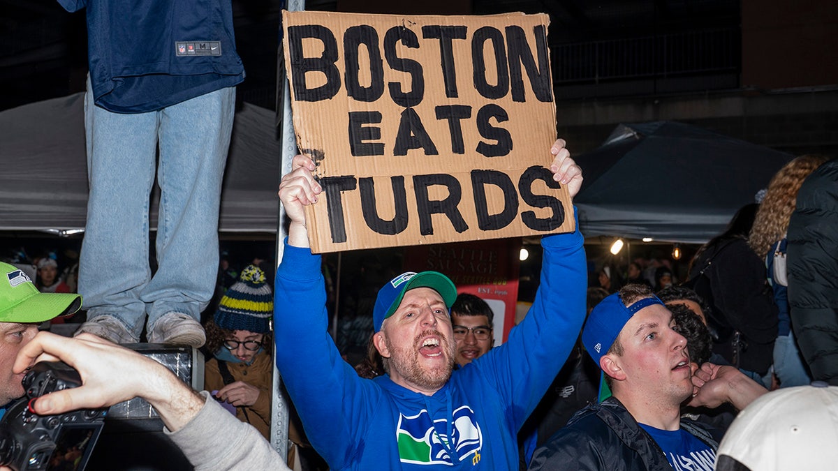 Seahawks fan holds a sign