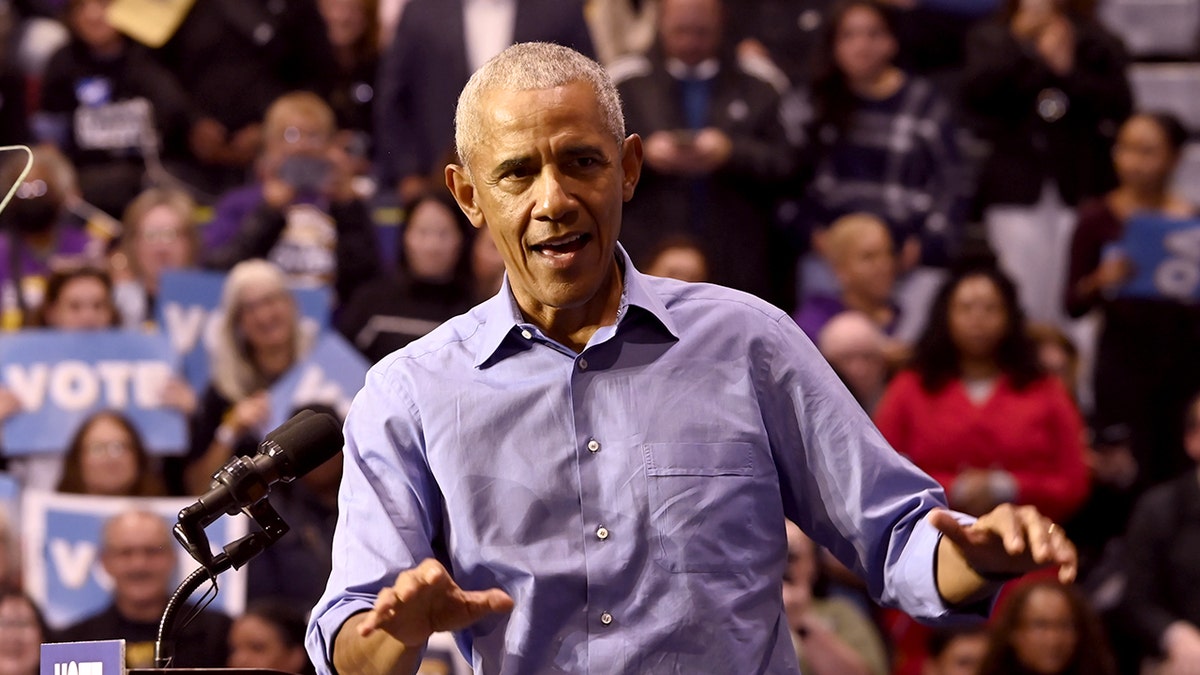 Former President Barack Obama and Mikie Sherrill standing at Essex County College gymnasium
