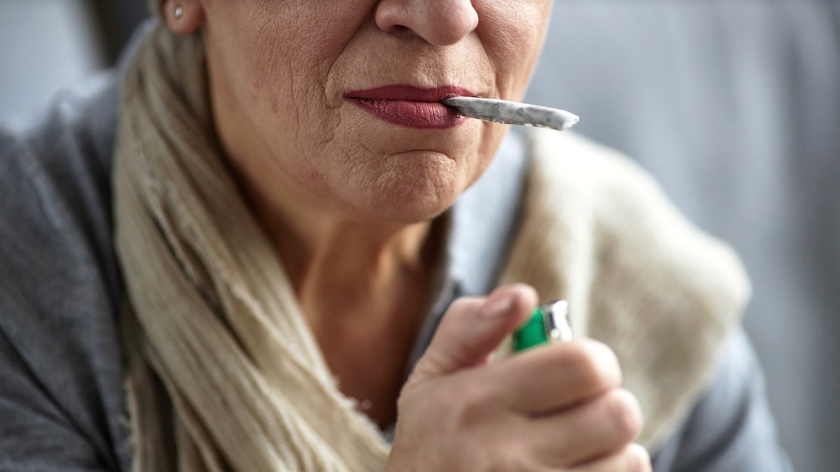 Older woman smoking a joint