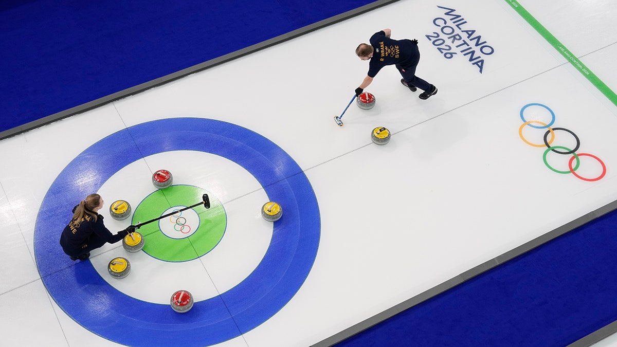 Athletes compete during a curling mixed doubles session