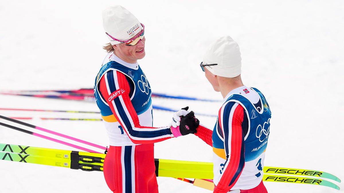Martin Loewstroem Nyenget shakes hands with gold medalist Johannes Hoesflot Klaebo
