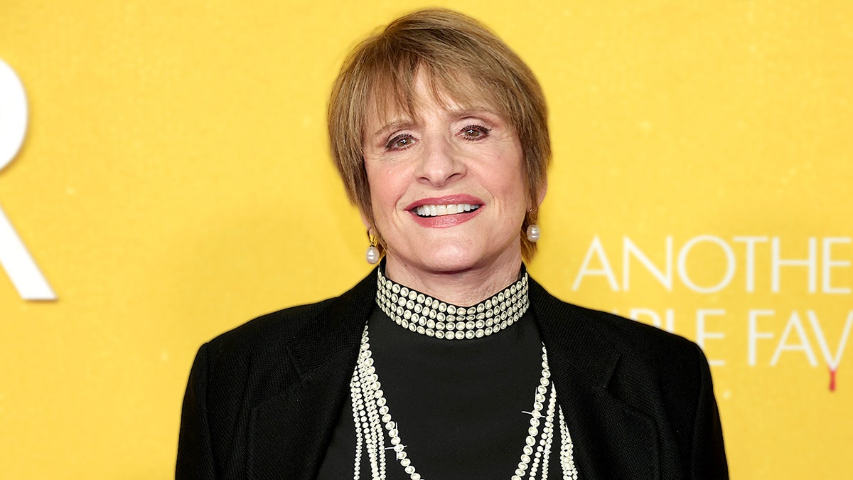 Patti LuPone poses for photographs while attending a film screening event.