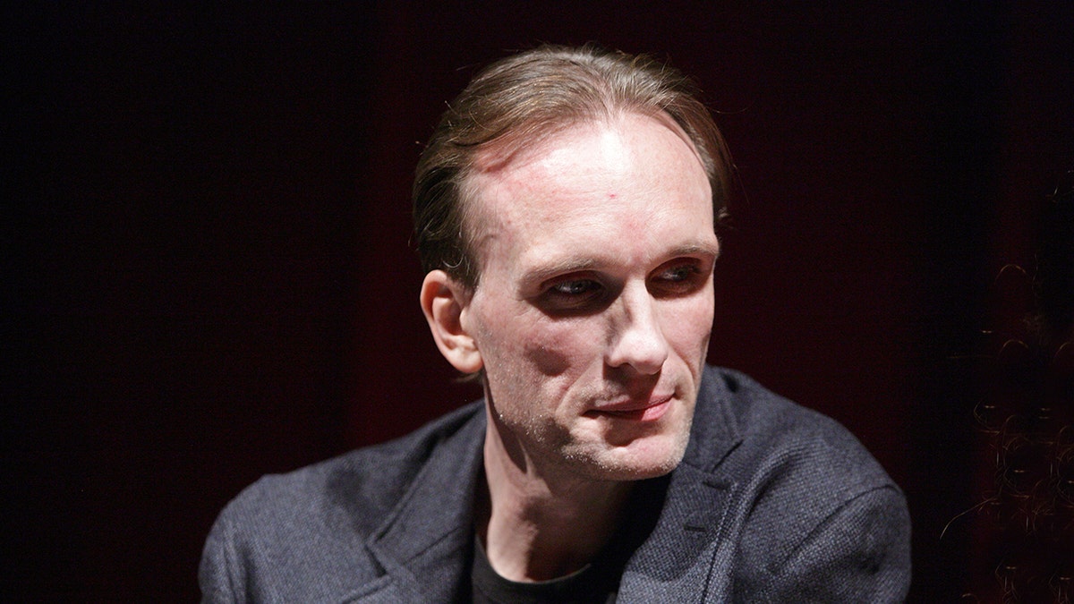 Peter Greene wearing gray