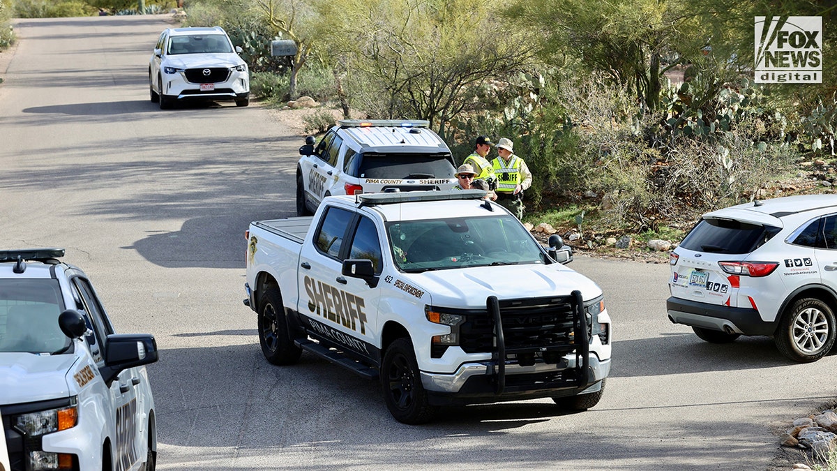 Pima County Sheriff's deputies assembling in front of Nancy Guthrie's home.