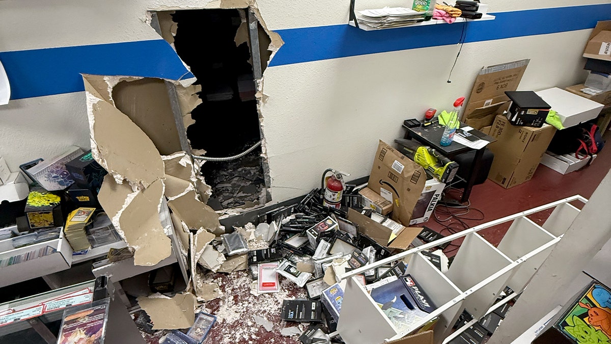 A whole in the store's wall and scattered merchandise