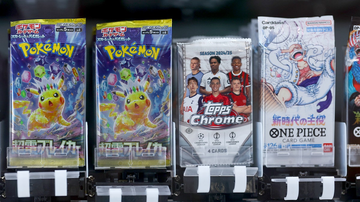 Assorted Pokémon and Topps trading card packs displayed inside a vending machine in Houston.